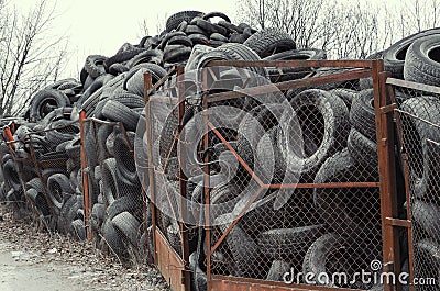 Old used damaged car tires at the dump Stock Photo