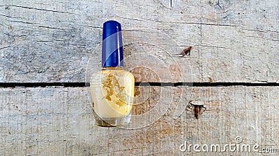 old used dirty nail polish bottle on wood cement background Stock Photo