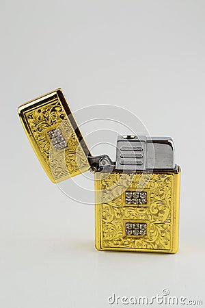 An old used luxurious gold open lighter Stock Photo