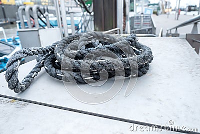 An old, used rope somewhere on a boat at the harbor Stock Photo