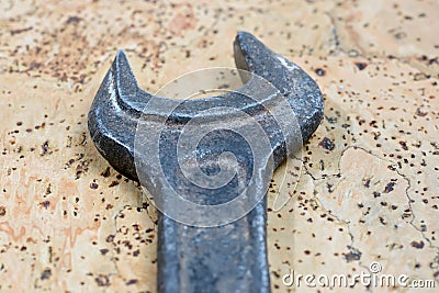 Old used wrench on a cork background. Vintage spanner Stock Photo