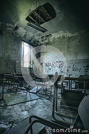 old and vandalised interior of a school classroom Stock Photo