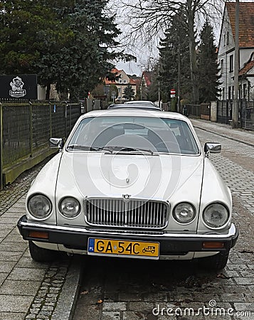 Old classic veteran ebony white Jaguar V12 Sovereign sedan executive parked Editorial Stock Photo