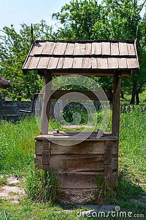 Old village well with a wood roof Stock Photo