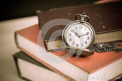 Old vintage books and pocket watches Stock Photo