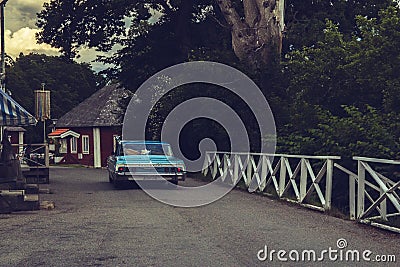 Old Swedish town with a vintage blue car Stock Photo