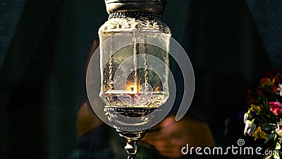 Old vintage church glow lamp with candle inside. Antique religious decoration of the east and west lantern. Holy fire as a symbol Stock Photo