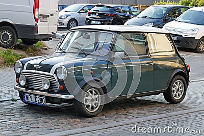 Old vintage classic dark green Morris Mini Cooper parked Editorial Stock Photo