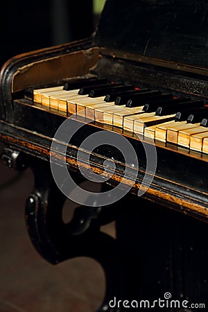 Old vintage classical black piano in dramatic light on dark back Stock Photo