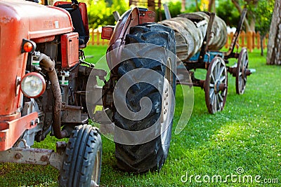 Old vintage farm tractor with cart Stock Photo