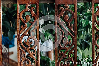 Old vintage fence on the terrace in Asia. Cracked paint, monogram. Stock Photo