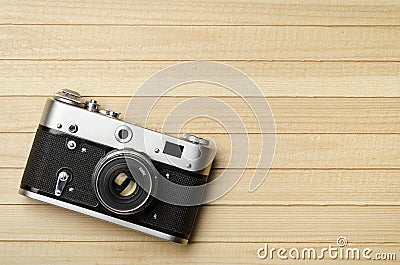 Old vintage film camera on wooden background, top view Stock Photo