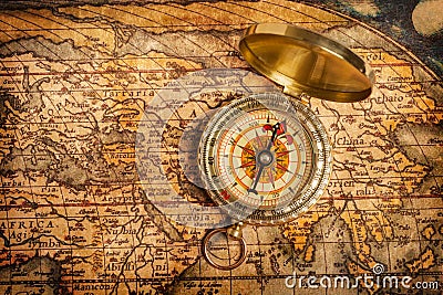 Old vintage golden compass on ancient map Stock Photo