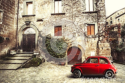 Old vintage italian scene. Small antique red car. Fiat 500 Stock Photo