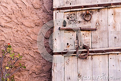 Old vintage massive wooden door with metal locker and handle Stock Photo