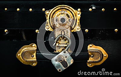 Old vintage retro box and padlock from treasure vault pirateÂ´s chest in gold color with rusty metal details Stock Photo