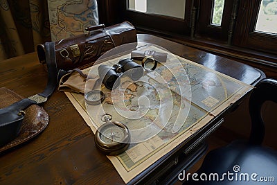 Old vintage retro compass and binoculars on ancient world map. Travel geography navigation concept background Stock Photo