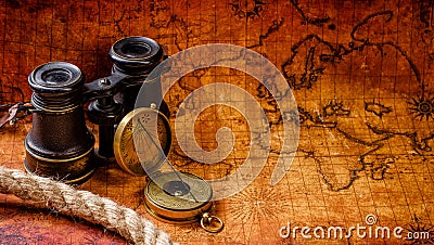 Old vintage retro compass and spyglass on ancient world map Stock Photo