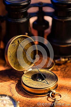 Old vintage retro compass and spyglass on ancient world map Stock Photo