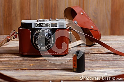 Old vintage retro photo camera Smena-8 on wooden background Editorial Stock Photo