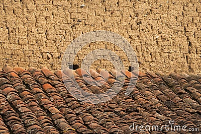 Old rural clay brick wall and roof Stock Photo