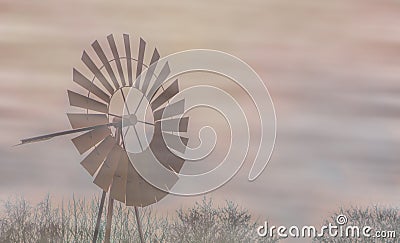A old vintage rusty windmill in the mist, classical landscape, agricultural or western background Stock Photo
