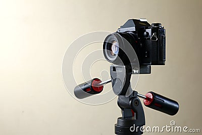 Old and vintage small format or 135mm film camera on a tripod Stock Photo