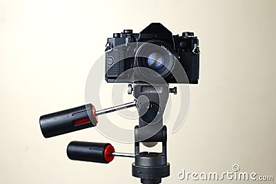 Old and vintage small format or 135mm film camera on a tripod Stock Photo