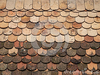 Old vintage style mossy weathered clay tile terracotta roof Stock Photo