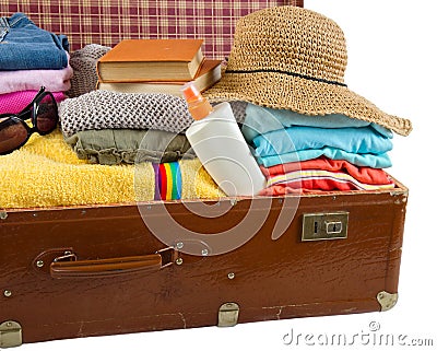 Old vintage suitcase packed with clothes and vacation accessories Stock Photo