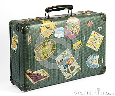 Old vintage suitcase with travel labels Stock Photo