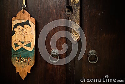 Old vintage Thai style of do not disturb sign hanging in a hotel Stock Photo