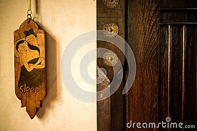 Old vintage Thai style of do not disturb sign hanging in a hotel Stock Photo