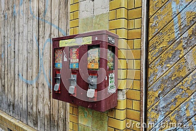 Vintage Gum Ball Machine on outdoor wall in Germany. Editorial Stock Photo