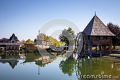 Old vintage water mill by the lake in ethno village Stanisici near the Bijeljina Editorial Stock Photo
