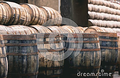 Old vintage whisky barrels filled of whiskey placed in order in Stock Photo