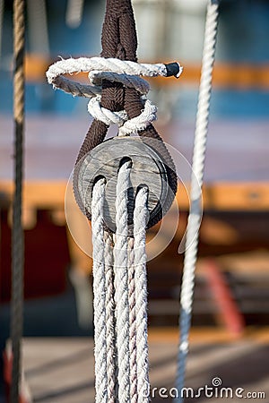 Old vintage wooden block with rigging ropes Stock Photo