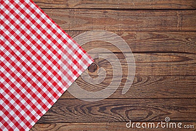 Old vintage wooden table with a red checkered tablecloth. Top view mockup. Stock Photo