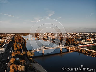 A city with houses, a river and bridges at sunset. the view from the top Stock Photo