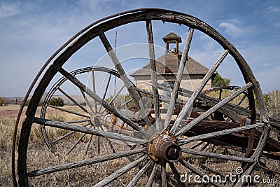 Old wagon whell at the Lower Shell School House, a converted in rural Bighorn County Wyoming Stock Photo