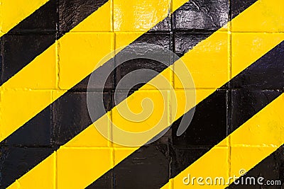 Old wall with black and yellow stripes surface. Warning or danger concept. Danger sign background. Stock Photo