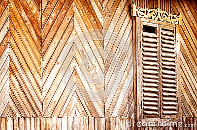 An old wall made of wooden slats with vintage carved shutters Stock Photo