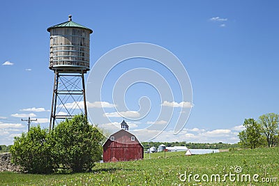 Old water cistern and red barn in rural Iowa Stock Photo