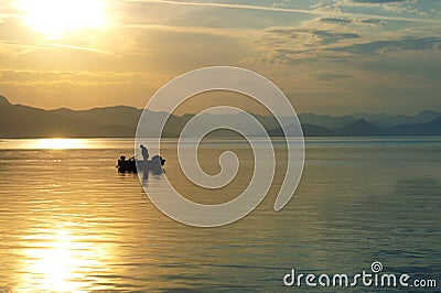 Sailing and fishing the old way of fishing at sunset Editorial Stock Photo