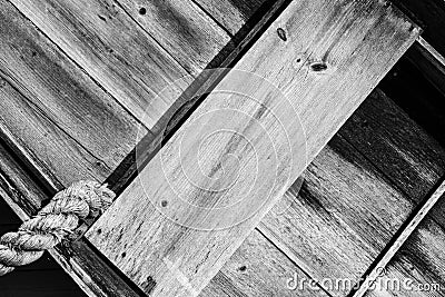 Old weathered boat with large anchor rope Stock Photo