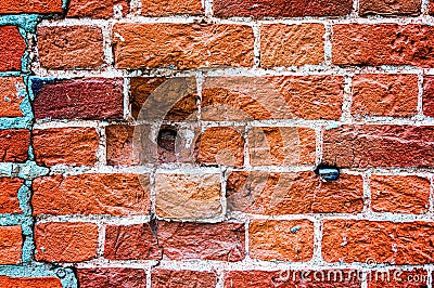 An old weathered fragment of a brick wall with cracks and round holes. Background for the designer. A large brick Stock Photo