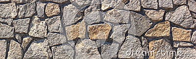 Old weathered gray stone wall on a city street, banner Stock Photo
