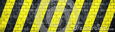 Old and weathered grungy brick wall with danger or attention black and yellow warning diagonal stripes texture background banner Stock Photo