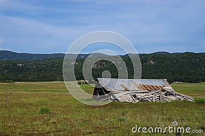 Old and Weathered Home Collapsed and Silent in the Forgotten Field Stock Photo