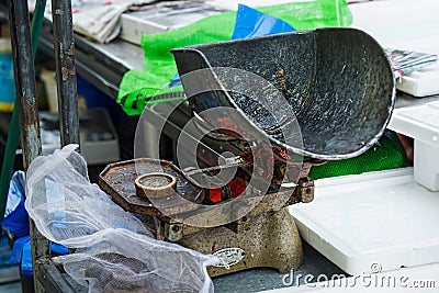 Old weighing machine on food fish market Editorial Stock Photo